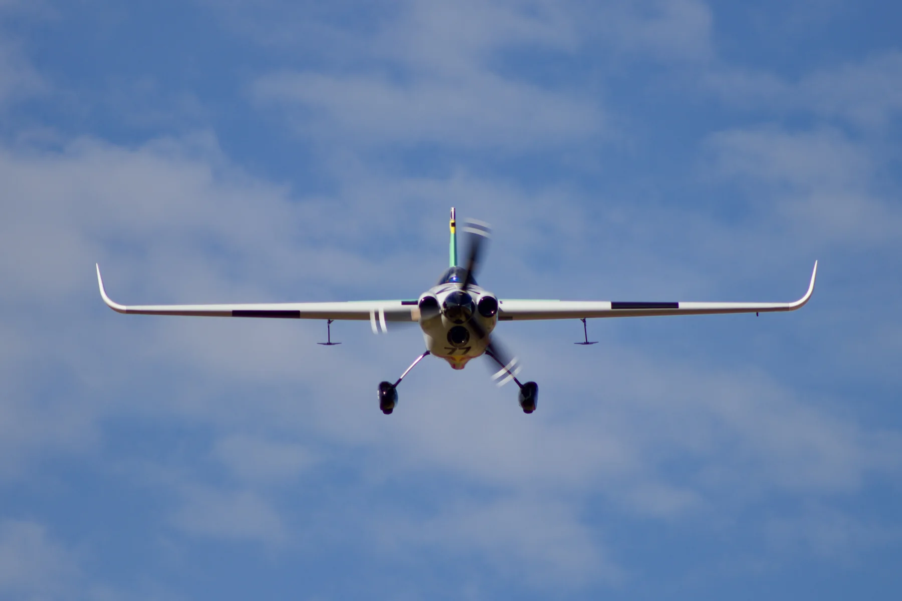 Head-on view of Patrick Davidson’s Emotive-liveried number 77 race aircraft in flight.