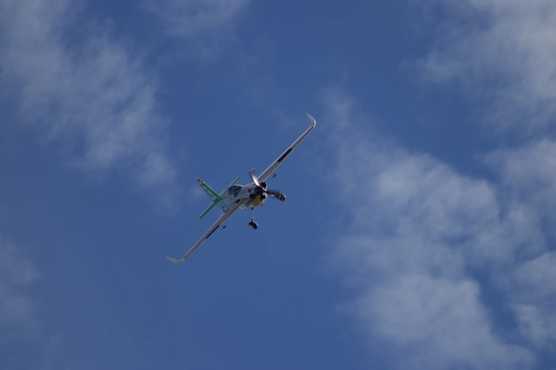Patrick Davidson’s Emotive-liveried race aircraft banking in flight.